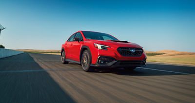 2026款斯巴鲁WRX tS运动轿车，红色车身，赛道行驶，全时四驱